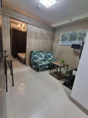 a living room with a couch and a table at 3sonstaycation in Manila