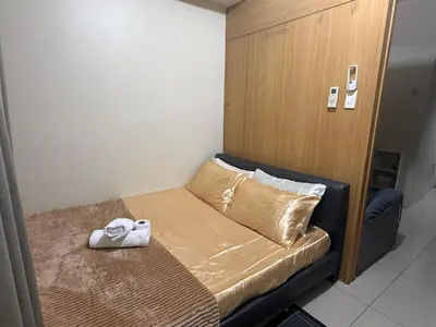 a small bed with a towel on it in a room at Sun&sky city escape in Manila
