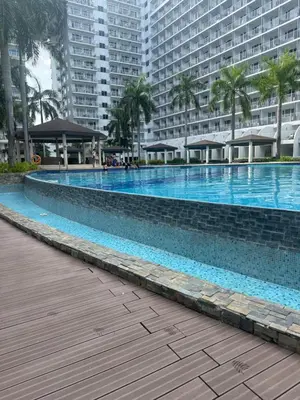 a large swimming pool in front of some buildings at Sun&sky city escape in Manila