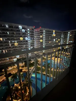 a view from the balcony of a hotel at night at Sun&sky city escape in Manila