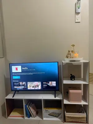 a flat screen tv sitting on top of a tv stand at Sun&sky city escape in Manila