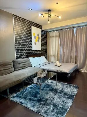 a living room with two beds and a couch at Makati City Poblacion 1 bedroom with balcony in Manila