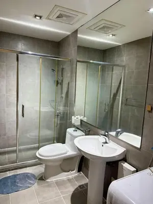 a bathroom with a toilet and a sink and a shower at Makati City Poblacion 1 bedroom with balcony in Manila