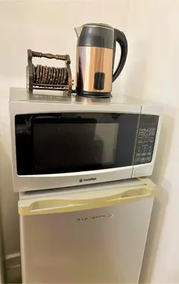 a microwave with a coffee pot on top of it at 1BR 4Pax Condo Azure Beach Resort Pool View Fully Furnished with PS4 in Manila