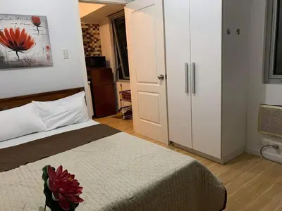 a bedroom with a bed and a white closet at Azure Urban Resort Residence Wavepool A52 in Manila