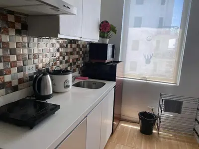 a small kitchen with a sink and a microwave at Azure Urban Resort Residence Wavepool A52 in Manila