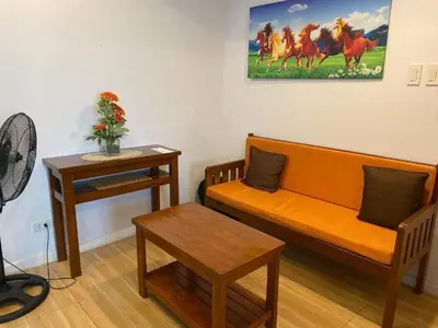 a living room with a couch and a table at Azure Urban Resort Residence Wavepool A52 in Manila