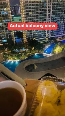 a plate of food with a view of a city at Azure Urban Resort Residence Wavepool A52 in Manila