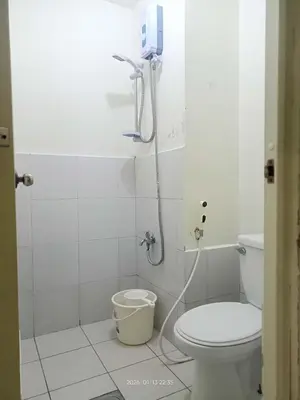 a bathroom with a shower and a toilet in it at Urban Deca Tower at Mandaluyong in Manila