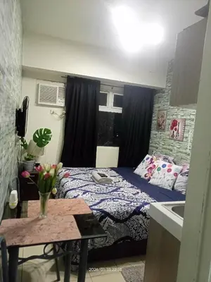 a small bedroom with a bed and a sink at Urban Deca Tower at Mandaluyong in Manila