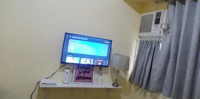 a computer monitor sitting on a shelf in a room at Urban Deca Tower at Mandaluyong in Manila