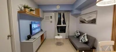 a small living room with a couch and a television at Avida Sucat Paranaque City in Manila