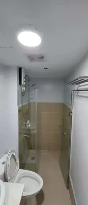 a bathroom with a shower and a toilet and a sink at Avida Sucat Paranaque City in Manila