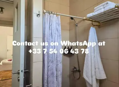 a bathroom with a shower with a shower curtain at Pure Stay Apartments in Manila