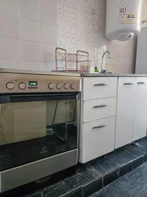 a kitchen with a stove top oven in a kitchen at Pure Stay Apartments in Manila