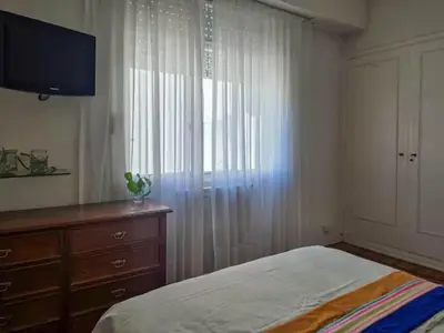 a bedroom with a bed and a dresser and a window at Pure Stay Apartments in Manila