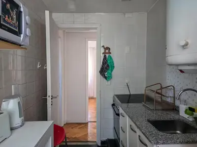 a kitchen with a sink and a counter top at Pure Stay Apartments in Manila
