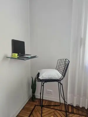 a chair in a room with a laptop on a table at Pure Stay Apartments in Manila