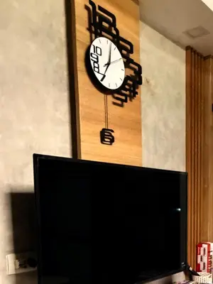 a clock on a wall next to a tv at Bayshore Getaway Condotel ByClowie in Manila