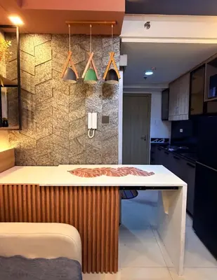 a kitchen with a table and a counter top at Bayshore Getaway Condotel ByClowie in Manila