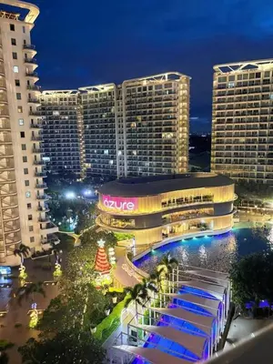 a view of a hotel at night with tall buildings at Dream Catchers Azure Staycation in Manila