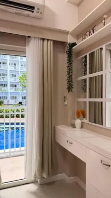 a bathroom with a window with a view of a building at Direct Access to pool GK Suite in Manila
