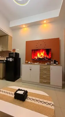 a living room with a fireplace in the wall at Direct Access to pool GK Suite in Manila