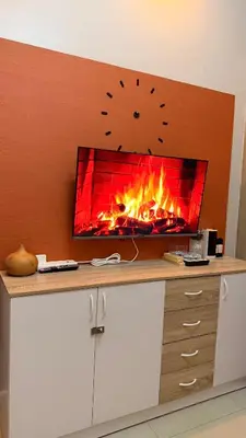 a fireplace on a wall with a fire in it at Direct Access to pool GK Suite in Manila