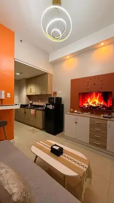 a living room with a fire in the fireplace at Direct Access to pool GK Suite in Manila