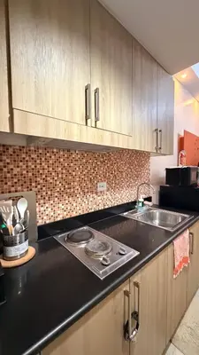 a kitchen with a sink and a counter top at Direct Access to pool GK Suite in Manila