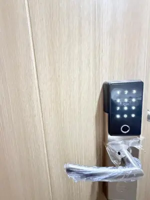 a small tv attached to a wall with a towel at Luxe Condo at MOA in Manila