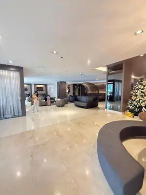 a large lobby with a person walking in a building at Luxe Condo at MOA in Manila