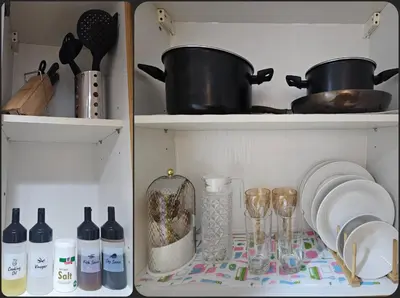 a kitchen shelf with wine bottles and wine glasses at Cozy 1BR Balcony Pool View with WiFi & Netflix near MOA and NAIA Airport in Manila