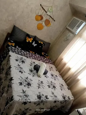 a bedroom with a bed with a black and white comforter at Urban Deca Tower at Mandaluyong in Manila