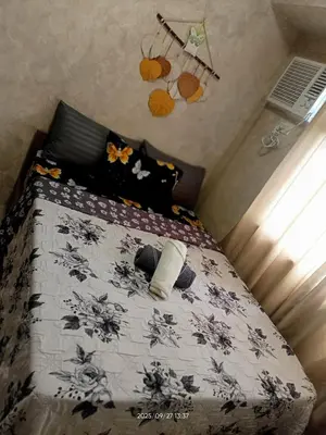 a bedroom with a bed with a black and white comforter at Urban Deca Tower at Mandaluyong in Manila