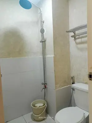 a bathroom with a shower with a toilet in it at Urban Deca Tower at Mandaluyong in Manila