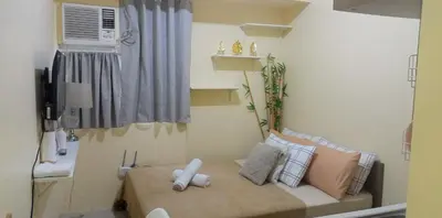 a small room with a bed and a window at Urban Deca Tower at Mandaluyong in Manila