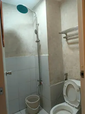 a bathroom with a shower with a toilet and a sink at Urban Deca Tower at Mandaluyong in Manila