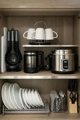 a kitchen shelf filled with dishes and utensils at 2 BR Fully Furnished Condo in Parañaque with Pool and Parking - Bloom Unit 1134 in Manila