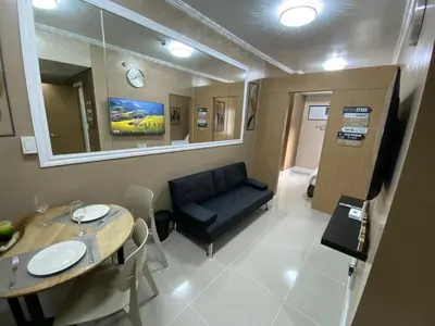 a living room with a couch and a table at 2 BR Fully Furnished Condo in Parañaque with Pool and Parking - Bloom Unit 1134 in Manila