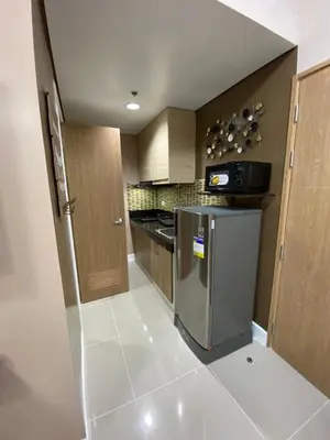 a kitchen with a stove and a refrigerator at 2 BR Fully Furnished Condo in Parañaque with Pool and Parking - Bloom Unit 1134 in Manila
