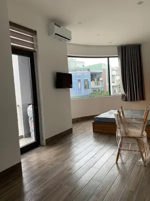 a bedroom with a bed and a chair and a window at Magallanes Escape in Manila
