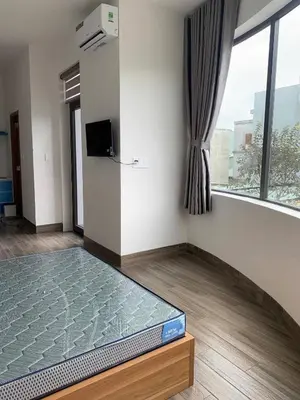 a bedroom with a bed in a room with a window at Magallanes Escape in Manila