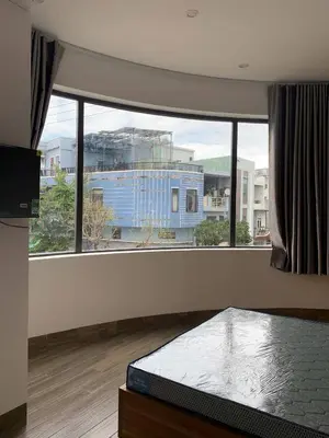 a room with a large window with a bed in front of it at Magallanes Escape in Manila