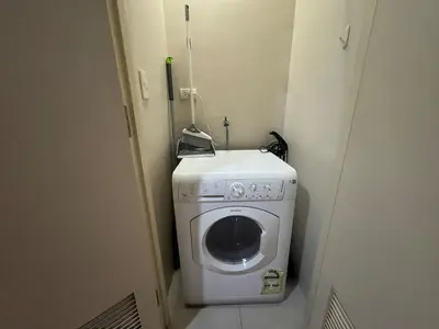 a washing machine in the corner of a room at BGC Luxe Condo I Facing Grand Hyatt & Uptown Mall in Manila