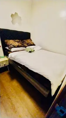 a bed with white sheets and pillows in a bedroom at MC Staycation at Spring Residences Near Airport in Manila