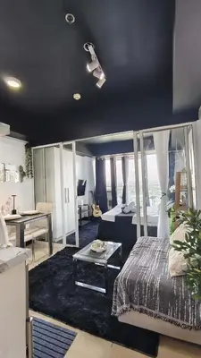 a bedroom with a bed and a table in a room at Upside Down in Manila