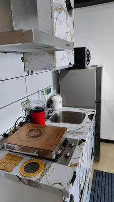 a kitchen with a sink and a counter top at Upside Down in Manila