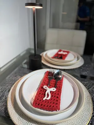 a table with two plates and a red napkin with a spoon at Upside Down in Manila