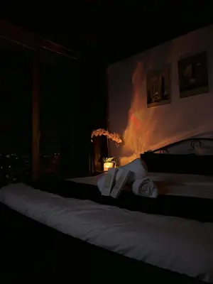 a bedroom with two beds in a dark room at Upside Down in Manila
